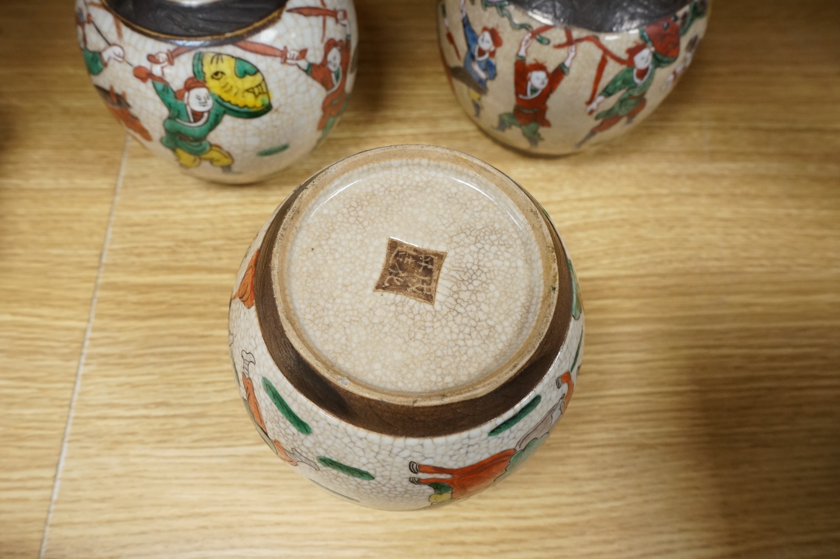 Three Chinese crackleglaze 'Warriors' jars without covers and two Chinese enamelled porcelain bowls. Largest bowl 20cm diameter.
